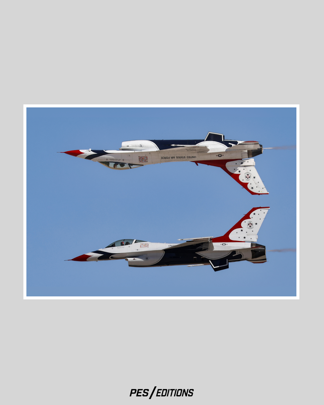 USAF Thunderbirds F-16s performing the Calypso Pass. Thunderbird #5 flies inverted directly above #6, mirroring each other against a blue sky.

