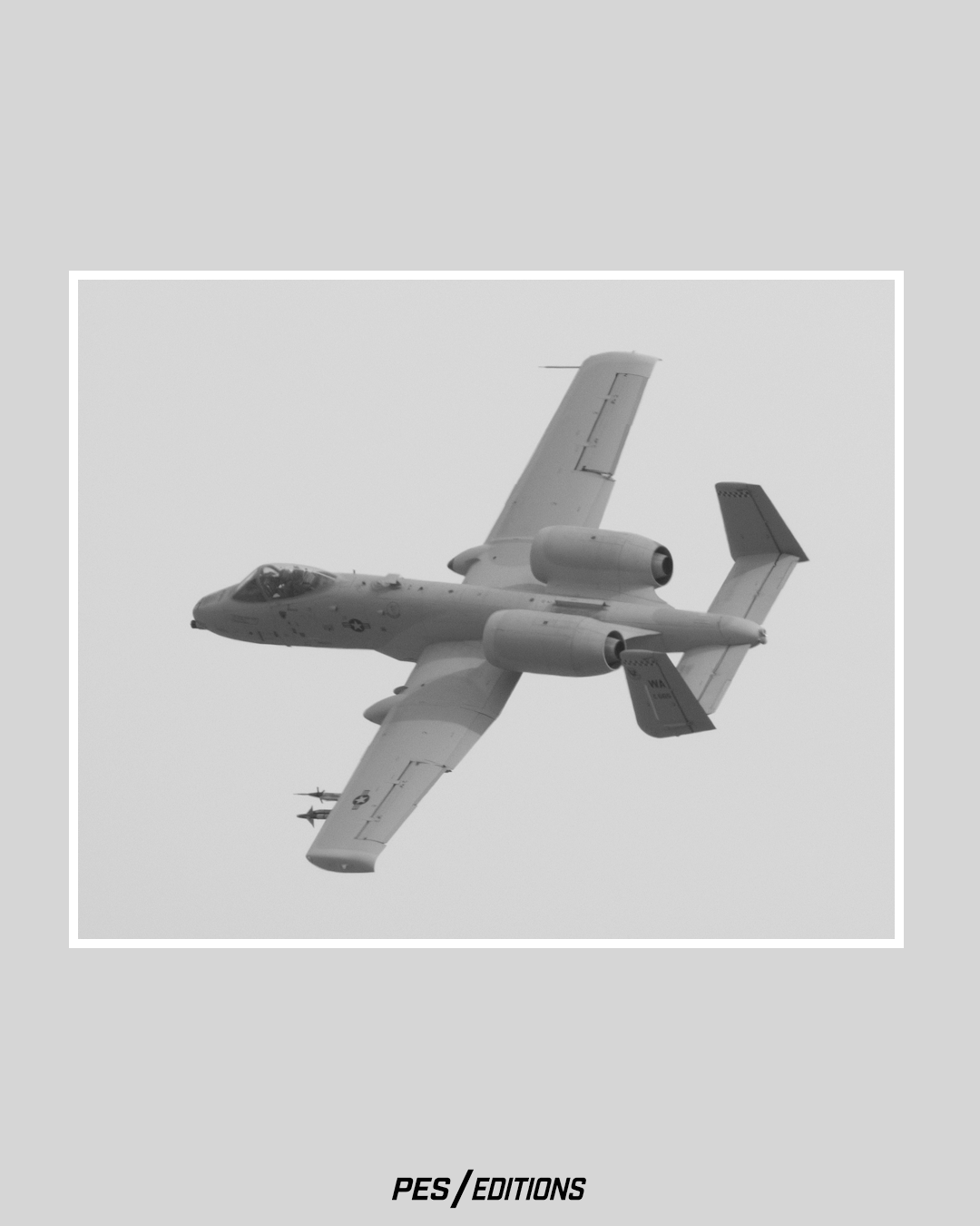 A US Air Force A-10 Thunderbolt II banking overhead. A gritty monochrome-style shot of the 