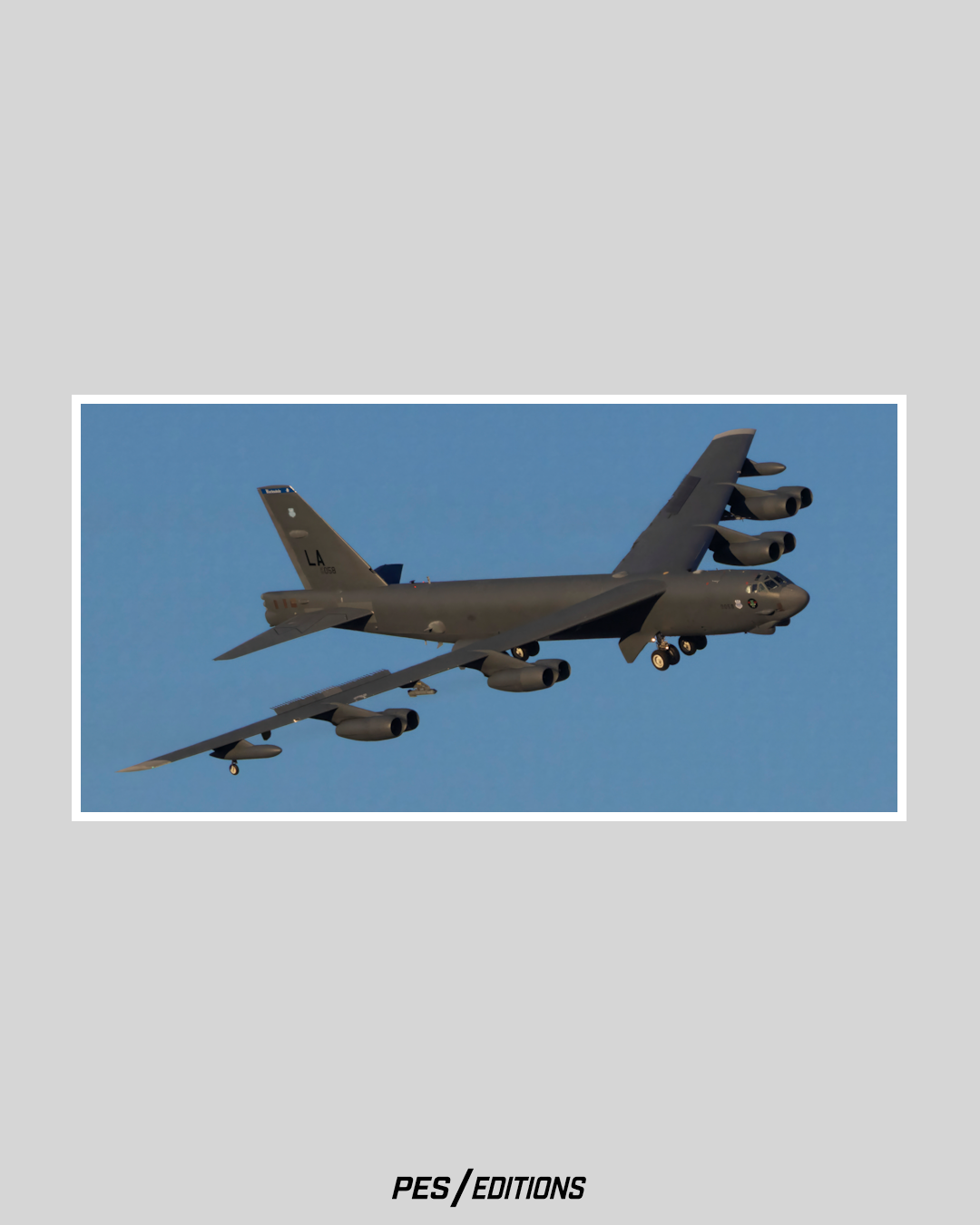 A B-52H Stratofortress from Barksdale AFB flying with gear down. A dramatic angle of the legendary eight-engine heavy bomber.