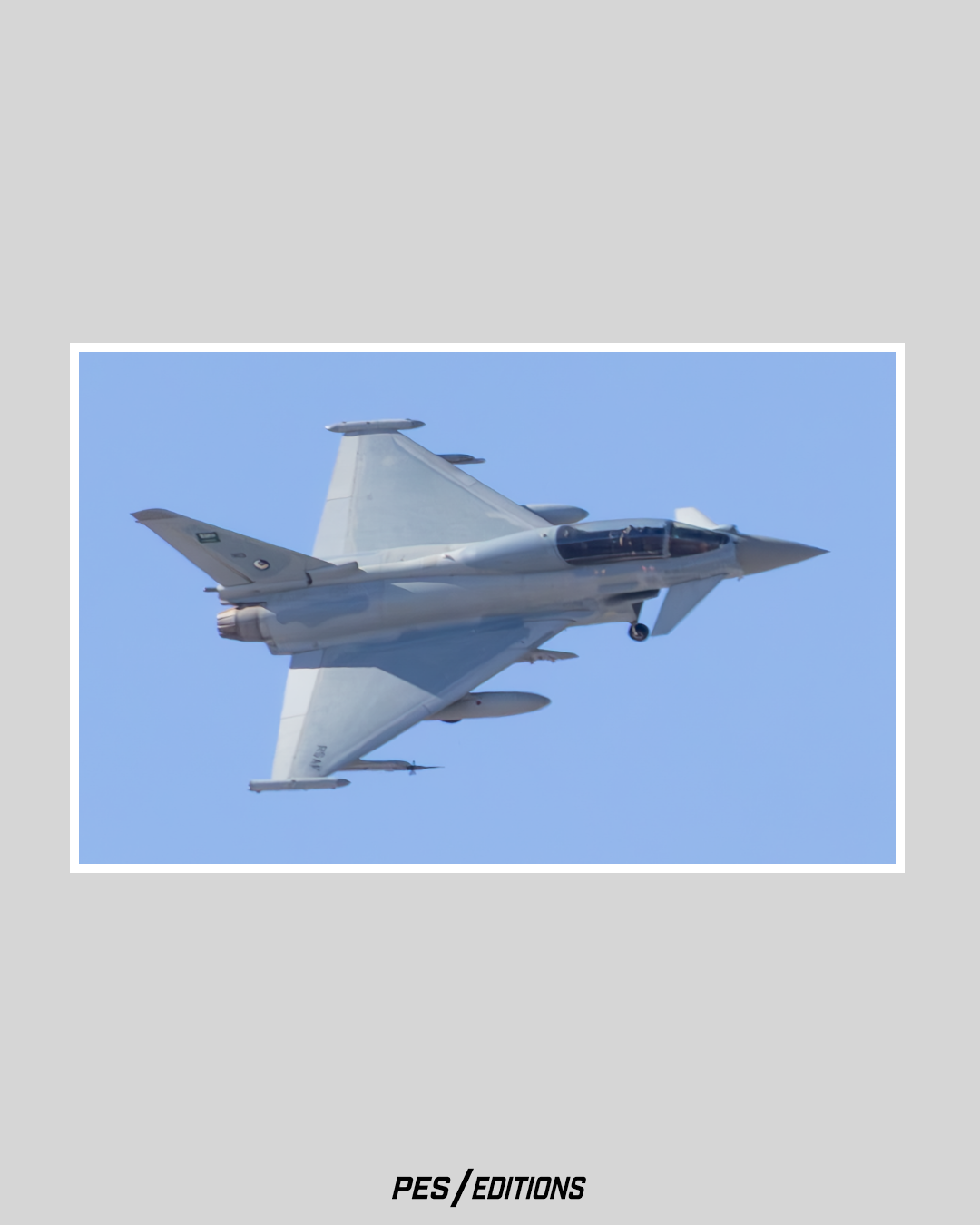 A solo Royal Saudi Air Force (RSAF) Eurofighter Typhoon banking aggressively, revealing its large delta wing shape and forward canards against the blue sky.