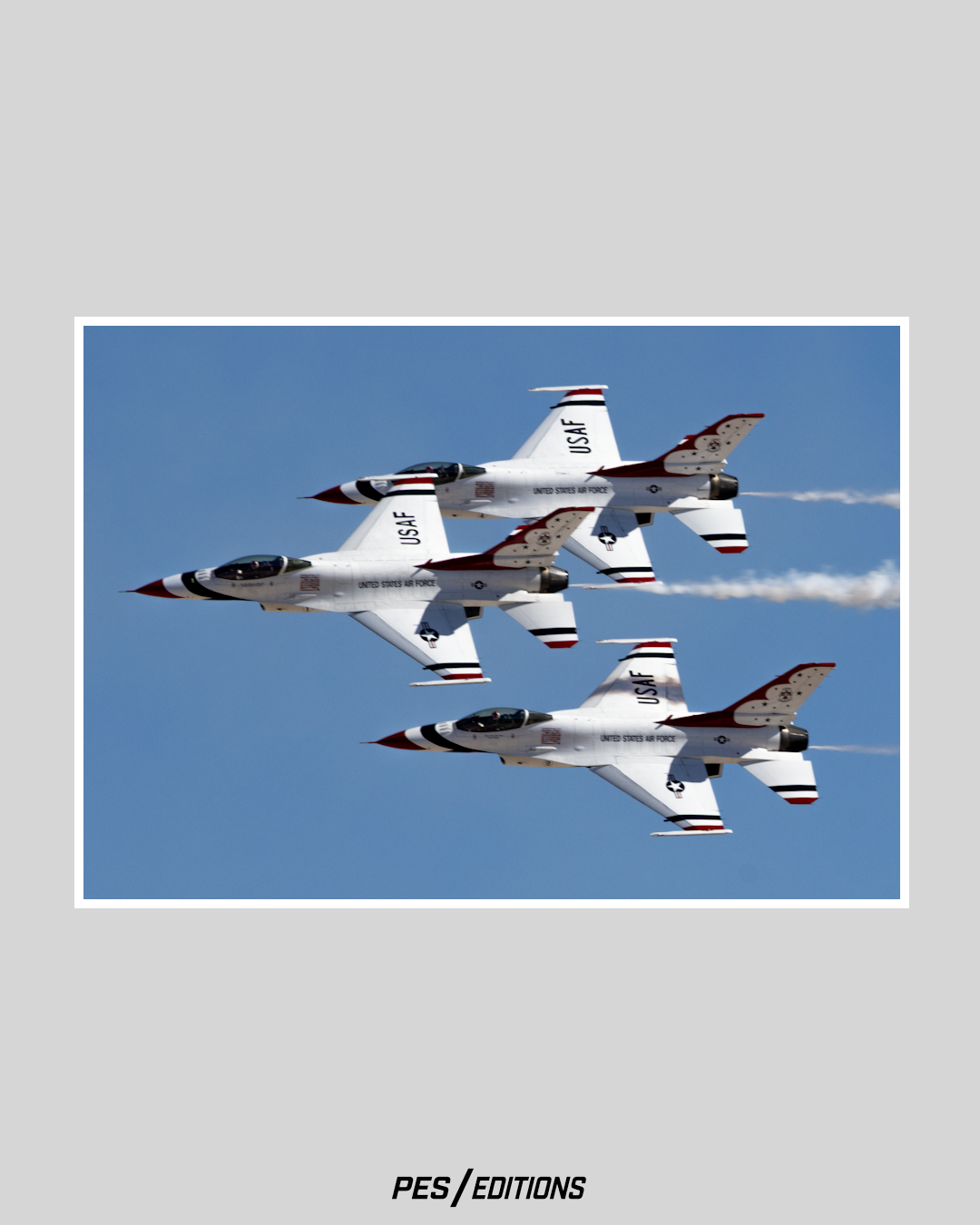 A trio of USAF Thunderbirds F-16s flying in a tight banking formation. The red, white, and blue jets display precision alignment.